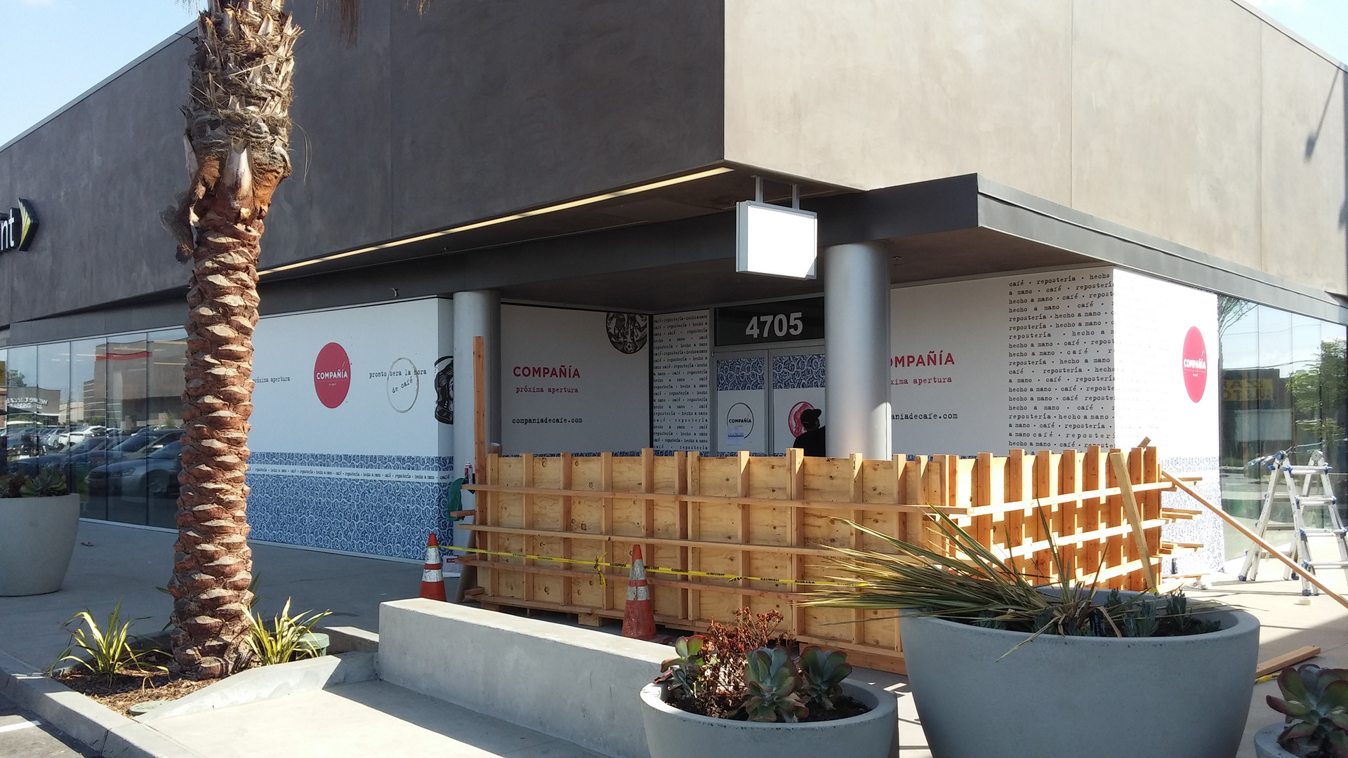 Compañía café storefront with branded window vinyl installed during build-out